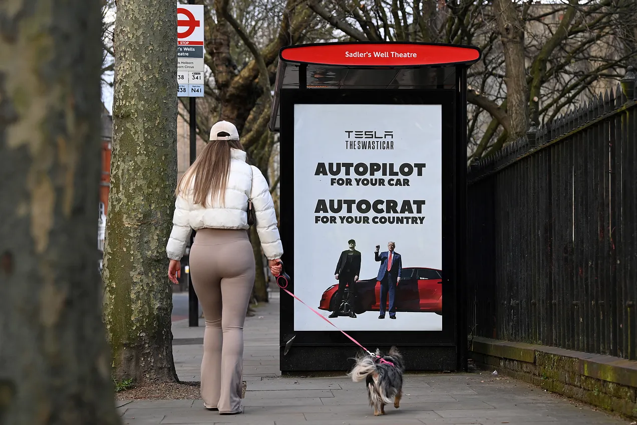 A London pedestrian walks past an anti-Trump-Musk poster yesterday installed by the “Everyone Hates Elon” group. (Robert Bodman-AFP via Getty)