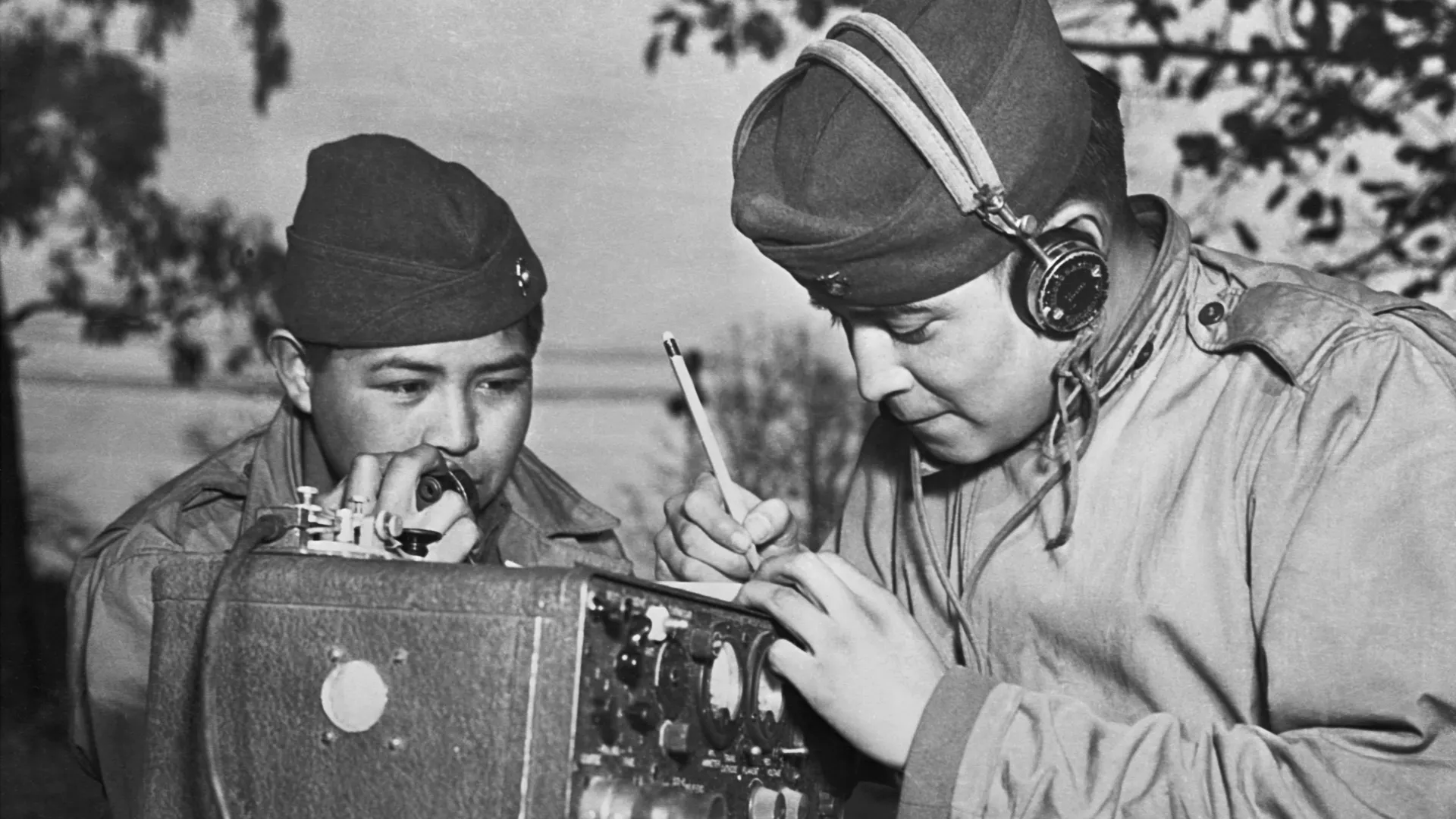 A two-man team of Navajo code talkers attached to a Marine regiment in the Pacific relay orders over the field radio using their native language