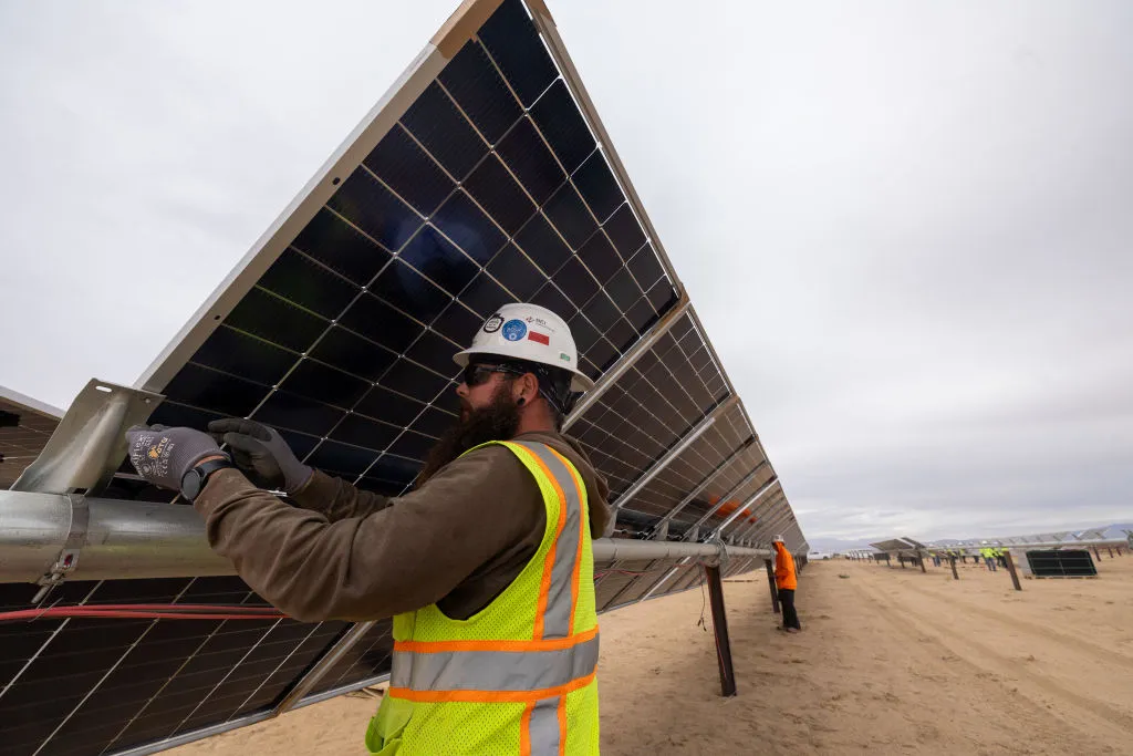 A worker installs solar panels for the Los Angeles Department of Water and Power's biggest solar and battery storage plant on Monday, Nov. 25, 2024 near California City, CA