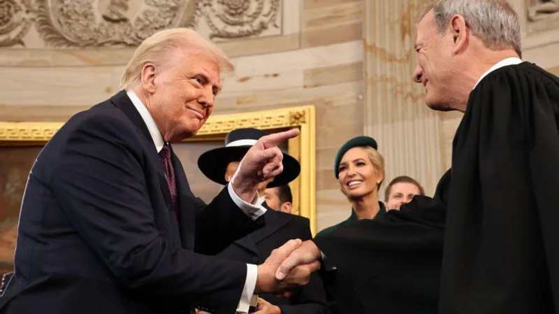 Donald Trump shakes hands with US Supreme Court Chief Justice John Roberts at the president's inauguration in January