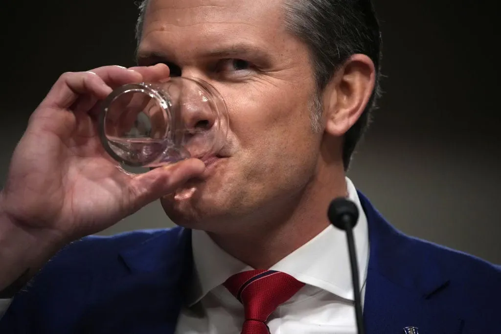 Hegseth drinking from glass