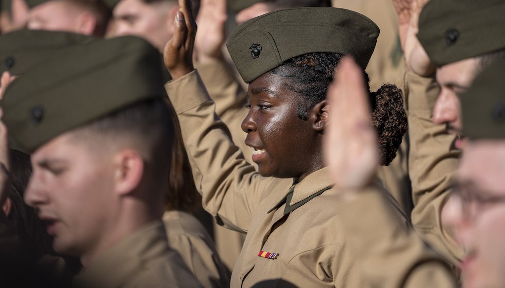 Lance Cpl. Samantha Harris, center, and others, re-enlist at the U.S. Marine Corps Memorial in February 2023. (AP)
