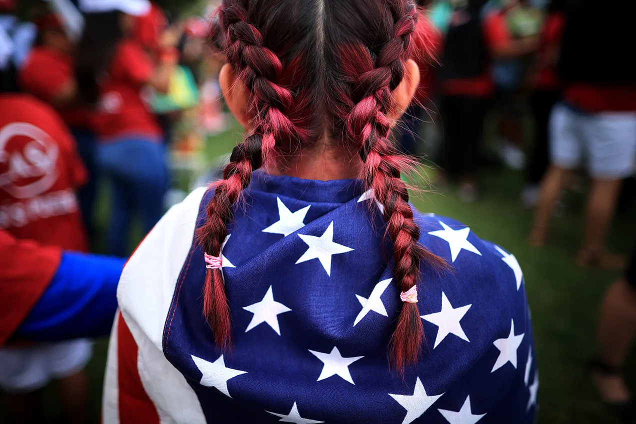 child draped in US flag