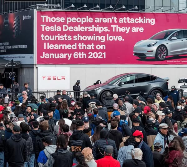 'tourists showing love' at Tesla dealership