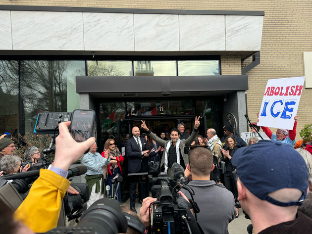 Mohsen Mahdawi flashes a peace sign outside the courthouse after U.S. District Judge William Sessions III ordered his release