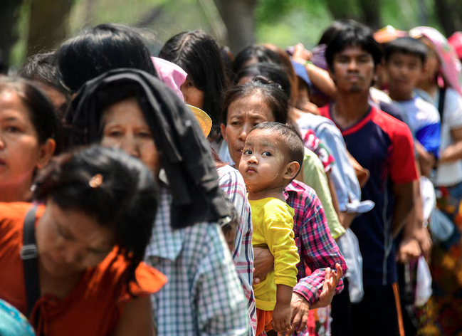 People queue for donated relief supplies following a strong earthquake in Mandalay, Myanmar, April 3, 2025