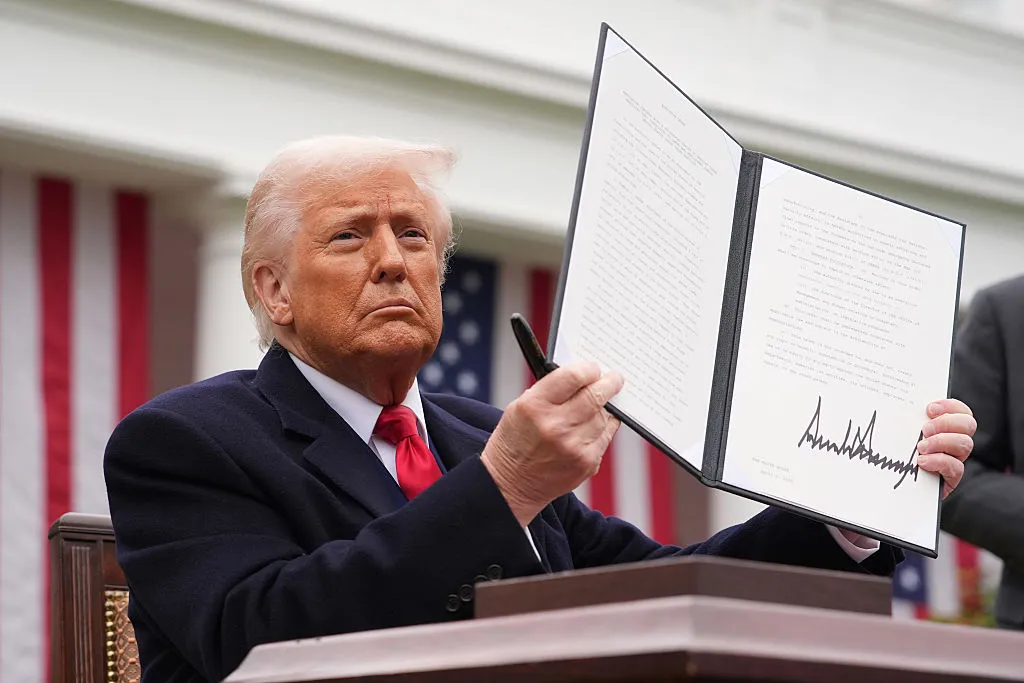President Trump displays an executive order imposing tariffs on imported goods during an event at the White House on April 2, 2025