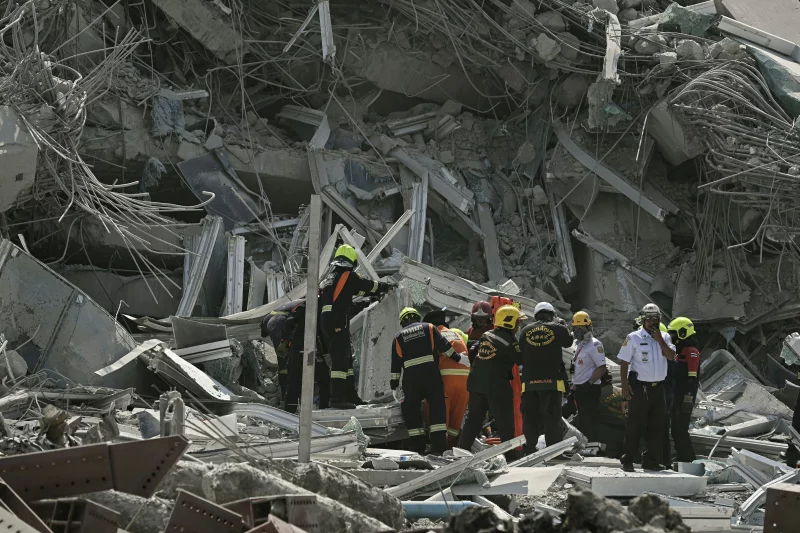 Rescue teams are seen at a site where a building collapsed in Bangkok on March 28 after an earthquake