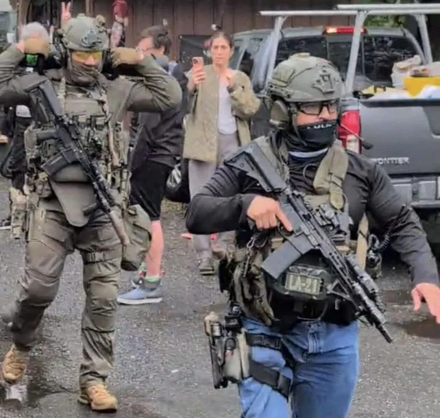 Immigration officers in the Triplex parking lot in downtown Great Barrington Tuesday morning arrested two men from the Barrington House apartments. The arrests drew a crowd that videotaped and questioned the officers