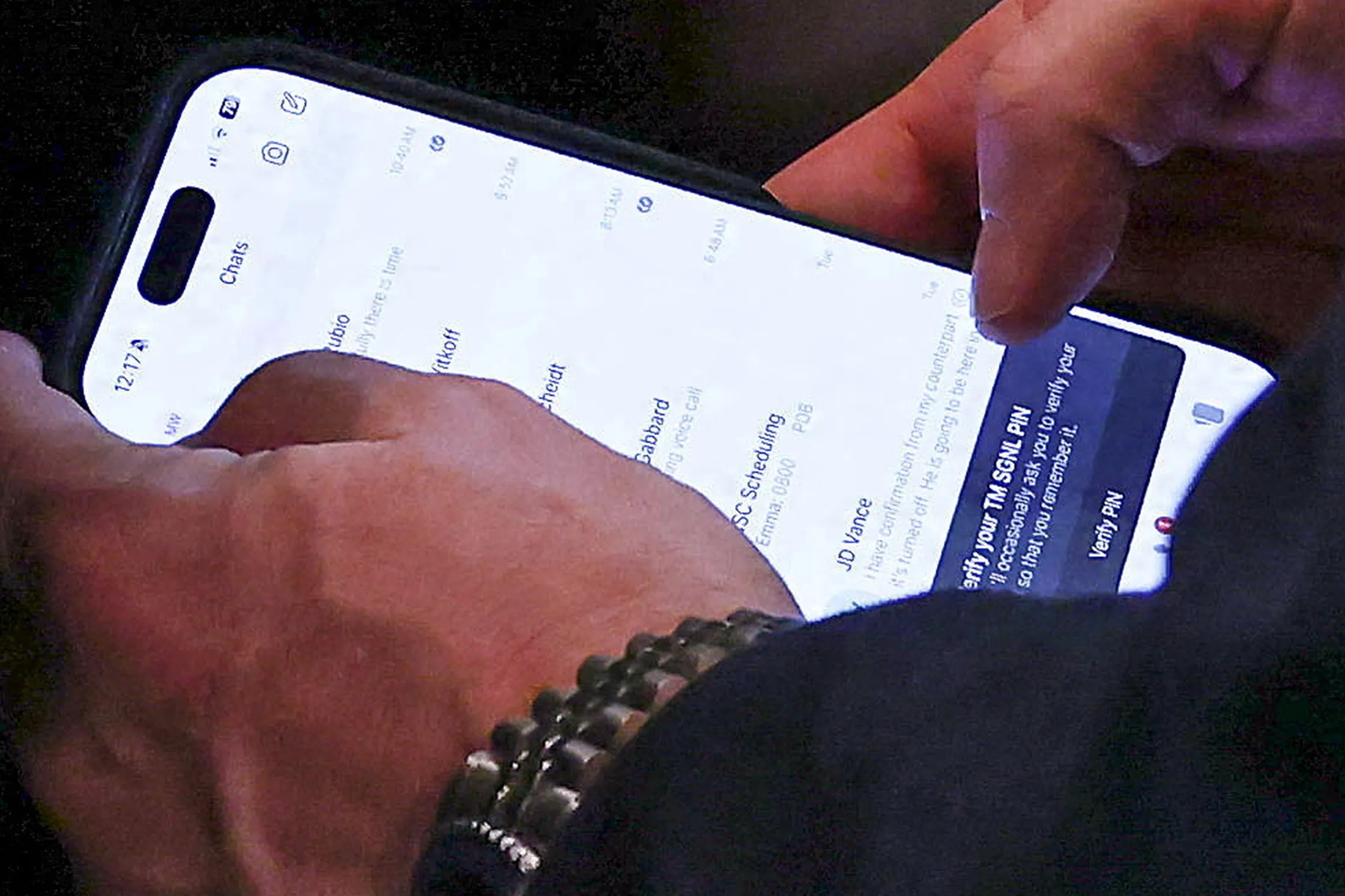 US National Security Adviser Mike Waltz checks his mobile phone while attending a cabinet meeting at the White House on April 30, 2025