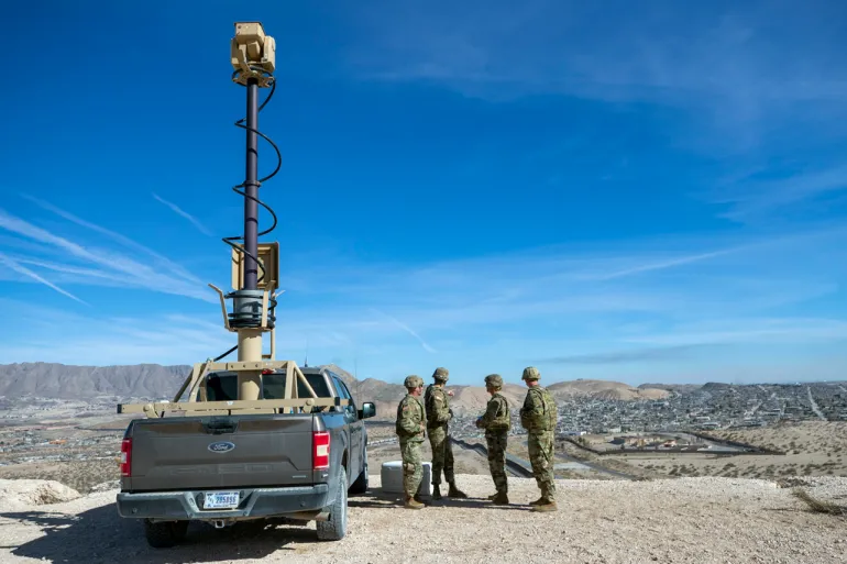 US soldiers inspect the border wall next to a surveillance vehicle in Sunland Park, New Mexico