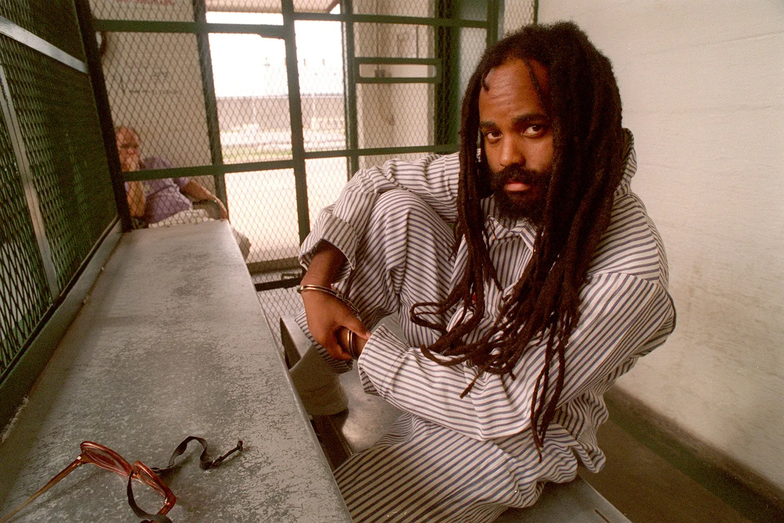 Dec. 17, 2001 - Philadelphia, Pennsylvania, U.S.- Former Black Panther and MUMIA ABU-JAMAL, seen in this undated file photo, will be spared the death penalty, the Philadelphia district attorney announced on Wednesday, bringing a quiet end to a racially charged case that spanned 30 years. (Credit Image: © April Saul/TNS via ZUMA Press Wire) Mumia Abu-Jamal behind bars in December 2001 © April Saul/TNS/ZUMA
