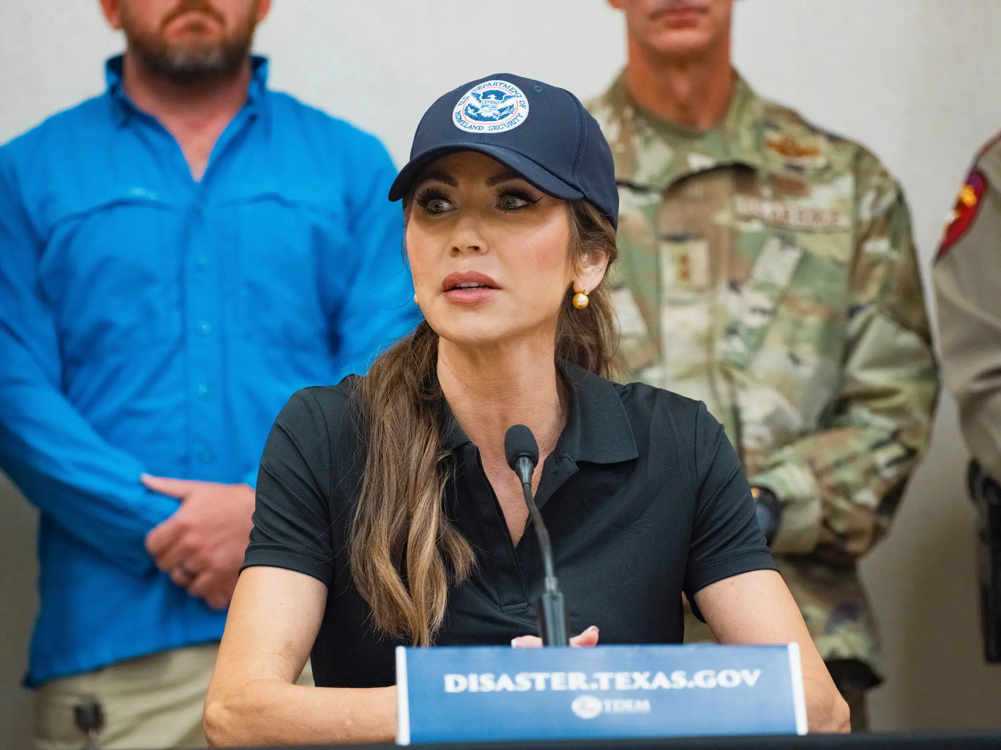 Homeland Security Secretary Kristi Noem at a news conference in Kernville, Texas, on Saturday. Ms. Noem did not renew a contract to staff call center workers until Thursday.Credit...Jordan Vonderhaar for The New York Times