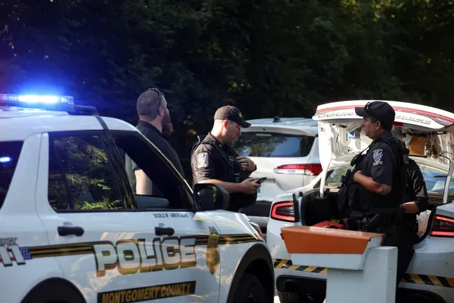 Police officers outside the home of the former White House national security adviser John Bolton as it is searched by Trump’s FBI. (Tasos Katopodis, REUTERS)