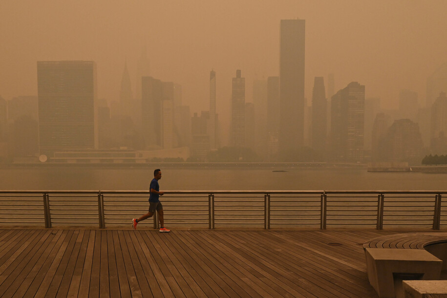 People walk along Park Avenue and Grand Central Terminal in New York City amid haze from Canada wildfires in June 2023.