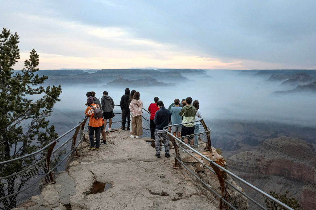 Tourists watch smoke from the Dragon Bravo wildfire float through the Grand Canyon. Scott Olson/Getty Images