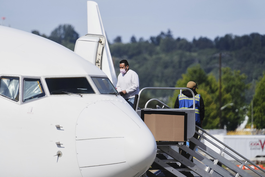 A detainee boards an ICE flight departing from King County International Airport-Boeing Field on Aug. 19 in Seattle, Wash.