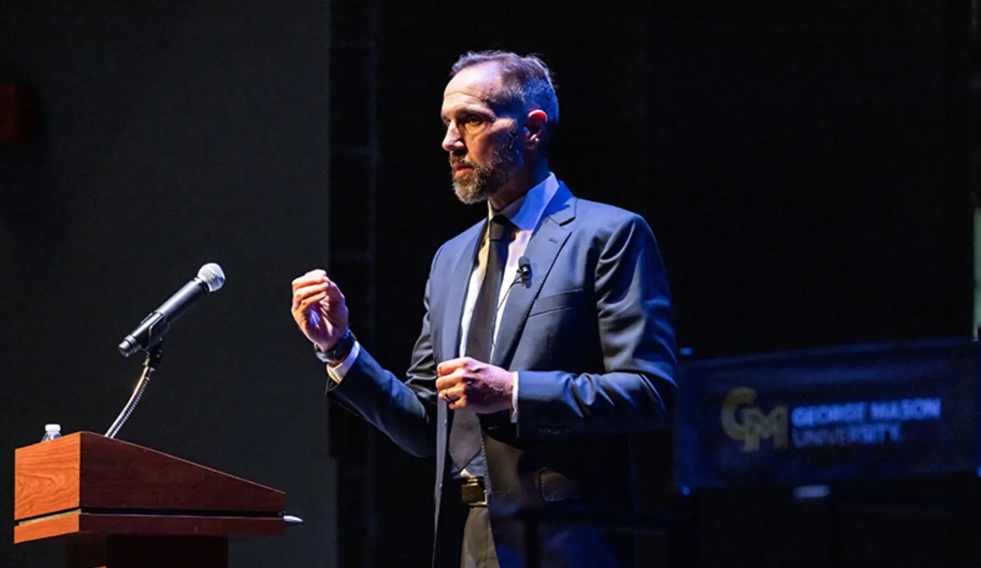 Jack Smith on the Harris Theatre stage: ‘What I see happening at the Department of Justice today saddens me and angers me.’ Photo by Ron Aira/Office of University Branding