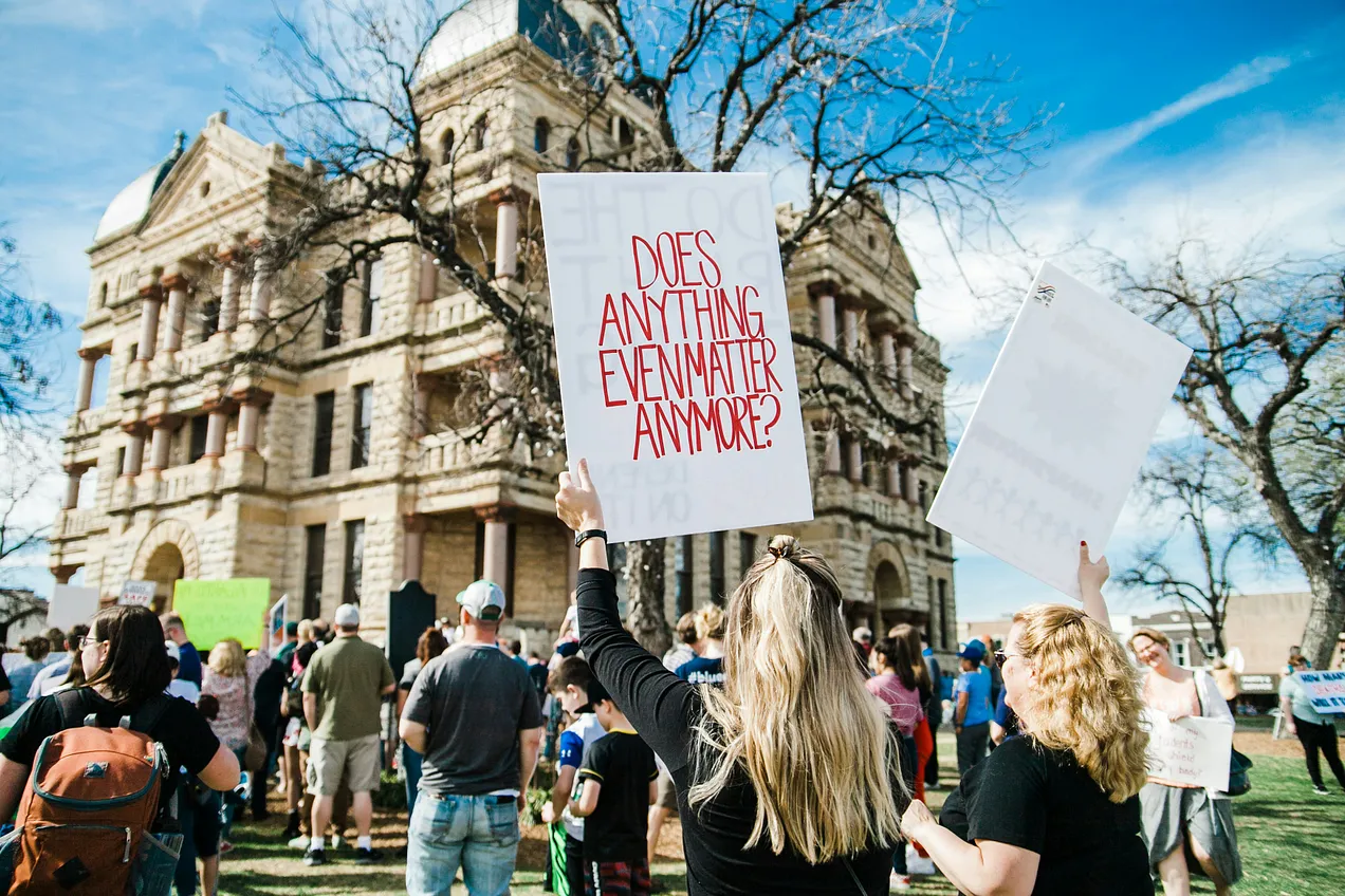 Photo by Heather Mount on Unsplash. “A poignant protest sign seen at the March for Our Lives rally in Denton, Texas.”
