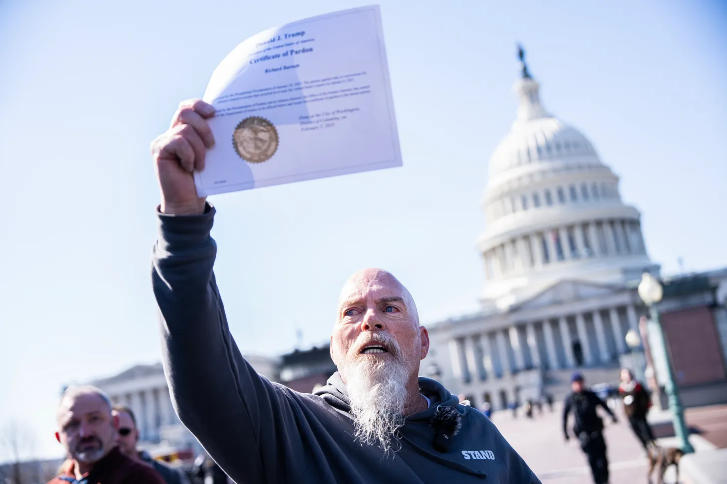 Richard “Bigo” Barnett shows off his Certificate of Pardon from President Donald Trump before a news conference with members of the Proud Boys, Oath Keepers, and other January 6th offenders who received pardons or commuted sentences, at the U.S. Capitol on Friday, February 21, 2025. (Tom Williams/CQ-Roll Call, Inc via Getty Images.)