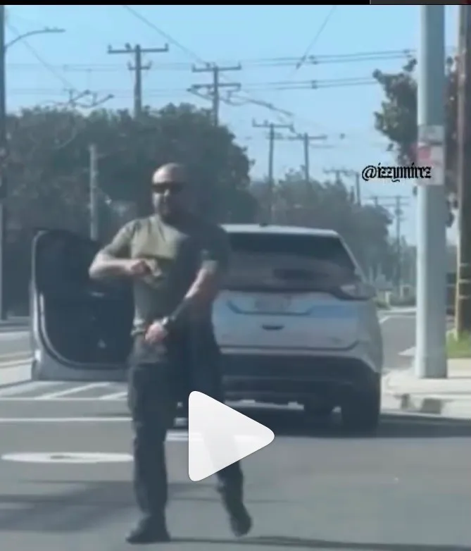 ICE agent holding gun