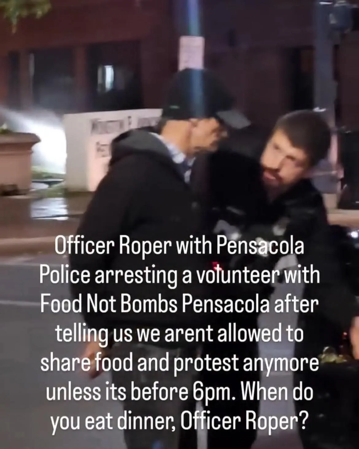 Officer arresting volunteer with Food Not Bombs Pensacola