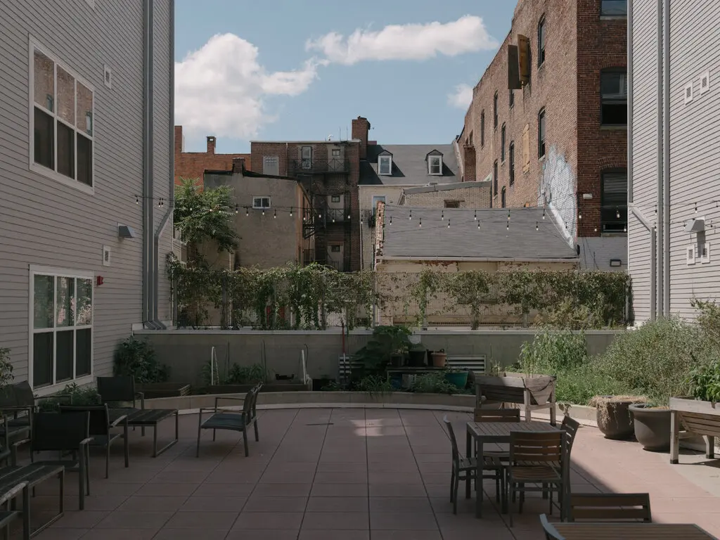 An outdoor seating area at a building that provides housing for homeless clients in Baltimore.Credit...Caroline Gutman for The New York Times