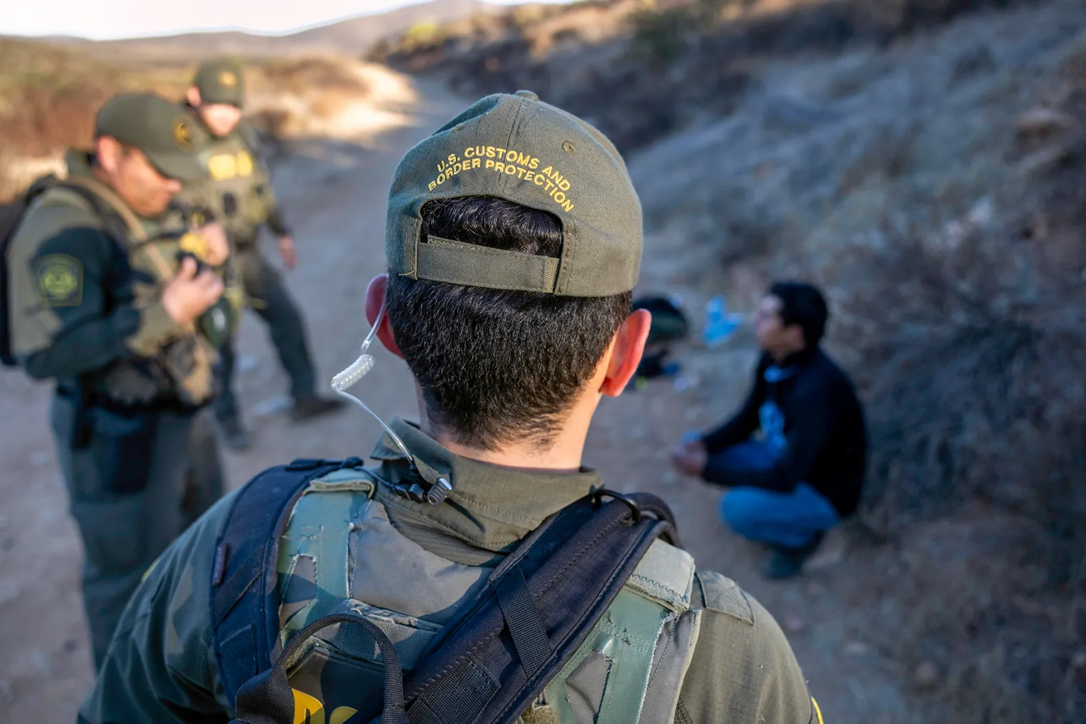 U.S. Border Patrol agents detain a migrant who had crossed the border from Mexico on Jan. 15, 2025 near Jamul, Calif. John Moore/Getty Images