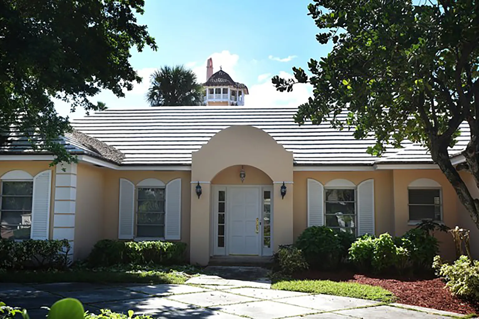 One of the two Palm Beach, Florida, homes that Donald Trump signed a mortgage for in the mid-1990s. The Mar-a-Lago tower appears behind the house. Melanie Bell/USA TODAY NETWORK via Imagn Images