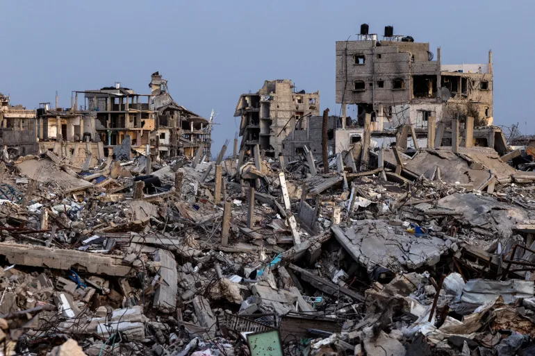 Buildings lie in ruins amid the rubble in Rafah, in southern Gaza, December 8, 2025 [Nir Elias/Reuters]