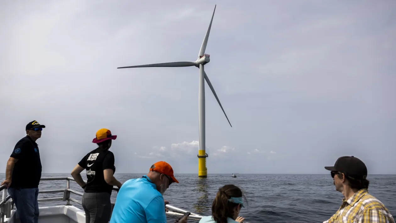 Employees of Dominion Energy gaze at one of two wind turbines located 27 miles off of Virginia Beach in the Atlantic Ocean on July 17, 2023. The two turbines are part of a pilot program for the Coastal Virginia Offshore Wind Program.Kendall Warner | Virginian Pilot | Tribune News Service | Getty Images