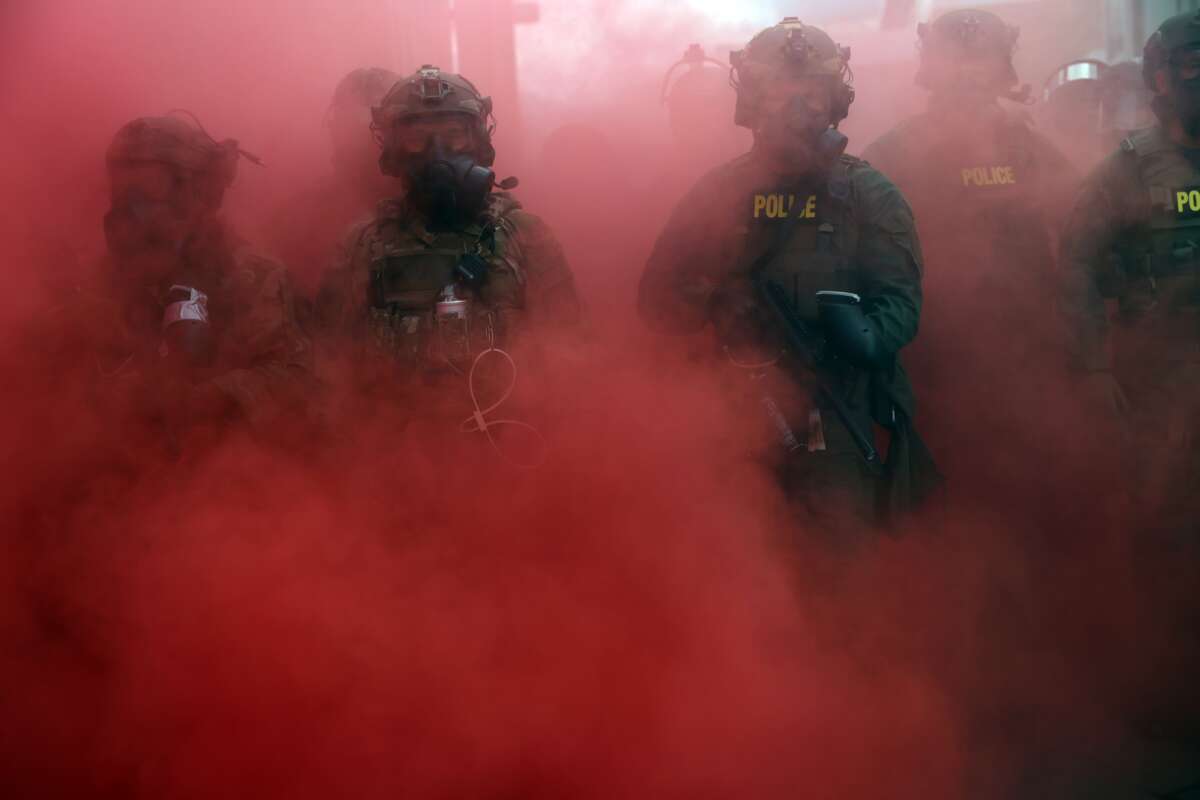 Federal agents, including members of the Department of Homeland Security and the Border Patrol, deploy a smoke grenade outside a downtown Immigration and Customs Enforcement facility in Portland, Oregon, on October 4, 2025.Spencer Platt / Getty Images