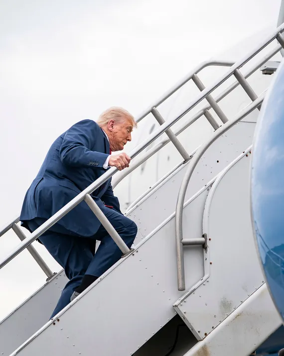 Trump climbing Air Force One stairs