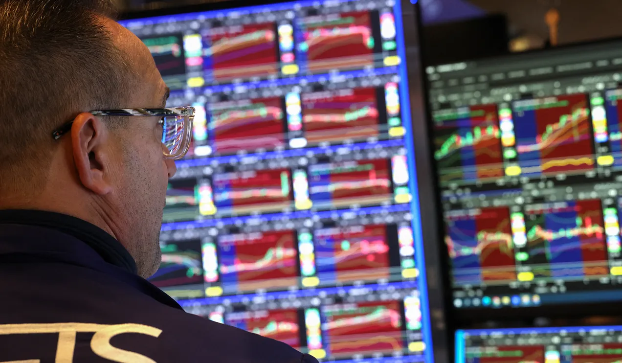 array of financial analysis graphs on multiple computer screens