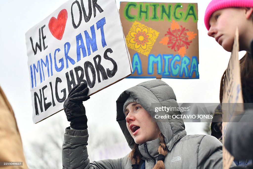 A protester holds up a sign as they march from Powderhorn Park in Minneapolis against Immigration and Customs Enforcement (ICE) and the fatal shooting of Renee Good by an ICE agent, calling on federal authorities to leave the city and demand accountability, in Minneapolis, Minnesota, on January 10, 2026. A US Immigration and Customs Enforcement (ICE) agent shot and killed 37-year-old Renee Nicole Good on the streets of Minneapolis on January 7, leading to huge protests and outrage from local leaders who rejected White House claims she was a domestic terrorist. (Photo by Octavio JONES / AFP via Getty Images)