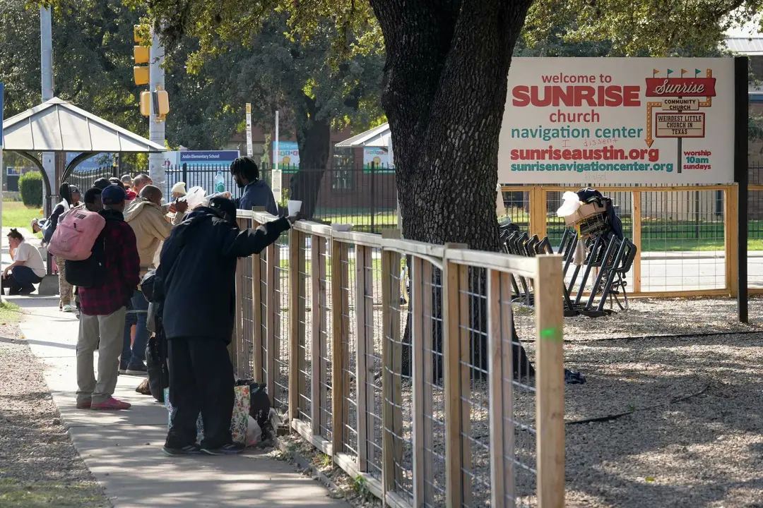 People stand on the sidewalk outside the Sunrise Community Church’s Homeless Navigation Center. Sunrise Executive Director Mark Hilbelink says the center’s mission is to “take care of the poor,” and that numerous laws, including the U.S. Religious Land Use and Institutionalized Persons Act, should protect the church from a state lawsuit.Jay Janner/American-Statesman