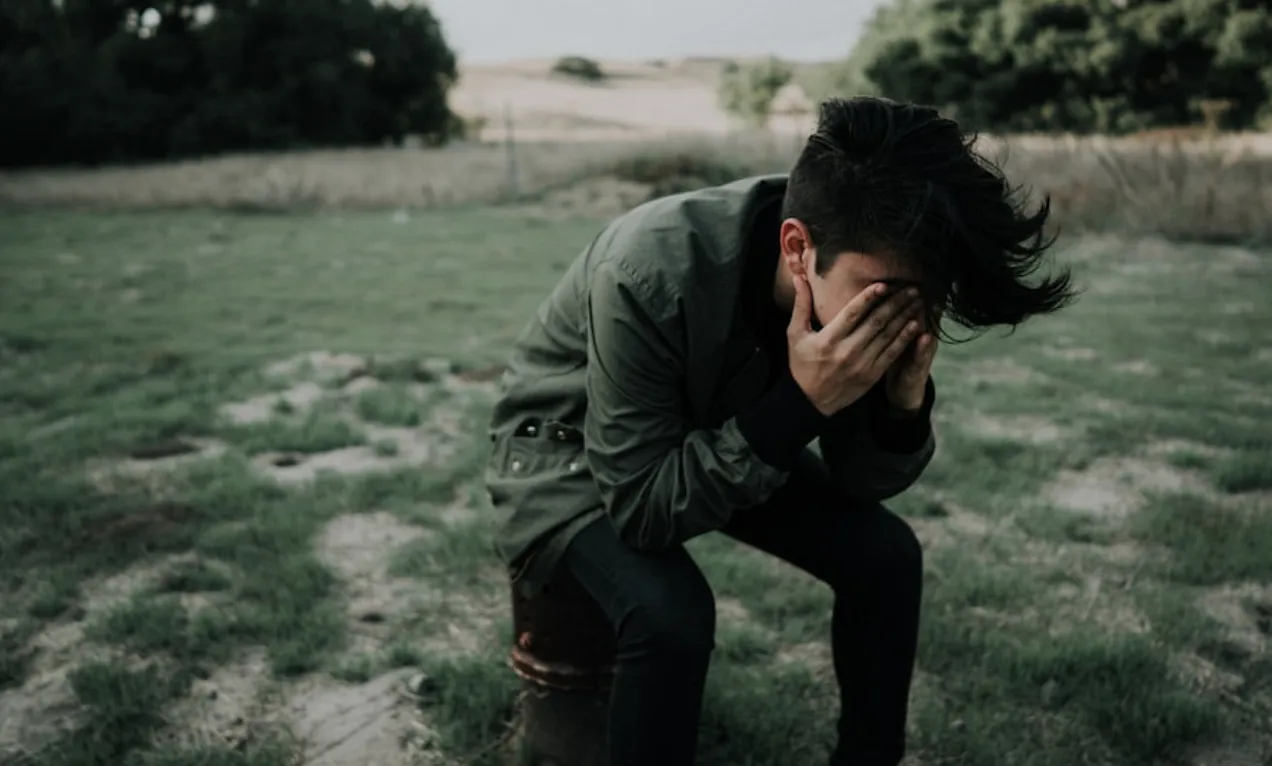 person covering their eyes