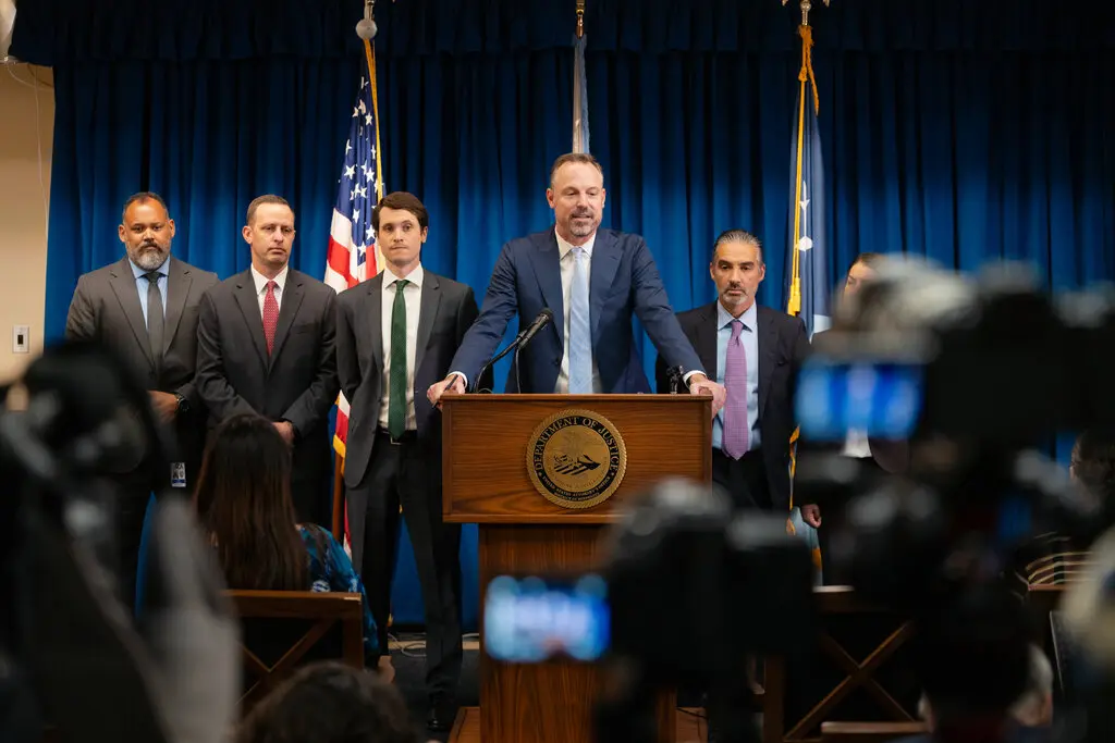 Joseph H. Thompson, center, at a news conference last year where he announced charges in a fraud scheme tied to Minnesota’s federally funded housing stabilization program.Credit...Ben Brewer for The New York Times