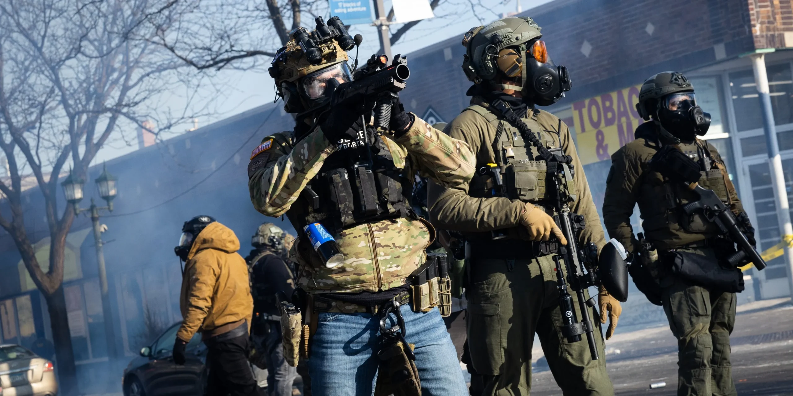 A Border Patrol agent aims a munition launcher at a crowd of people near the intersection of 27th Street and Nicollet Avenue in Minneapolis after a federal officer shot and killed 37-year-old Alex Pretti on Jan. 24, 2026. Photo: Ben Hovland/Minnesota Public Radio via AP