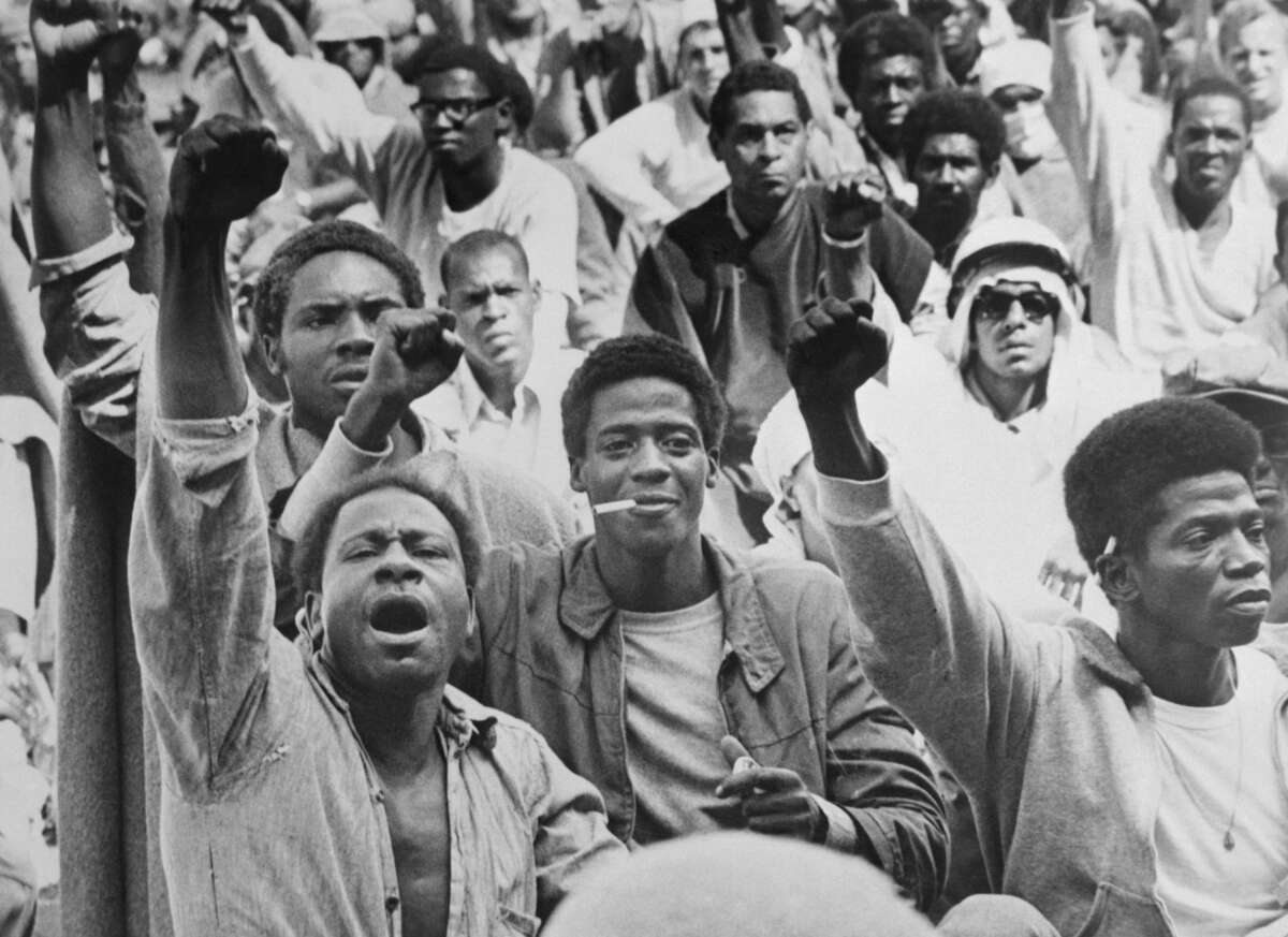 Prisoners at the Attica Correctional Facility give the Black Power salute on September 10, 1971. “I believe the connection between abolition and Black anti-fascism is crystallized in the writings and activism of political prisoners and prison abolitionists,” says scholar Jeanelle K. Hope. “The Attica prison uprising of 1971 stands as a major inflection point in this history.”Bettmann / Contributor / Getty Images