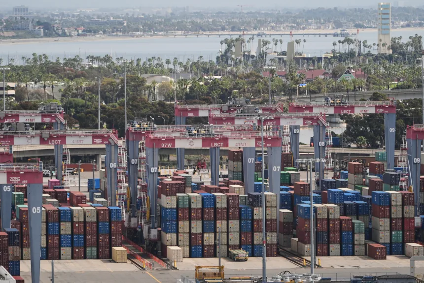 Containers are stacked at the Port of Long Beach Friday, Feb. 20, 2026, in Long Beach, Calif. (AP Photo/Damian Dovarganes)
