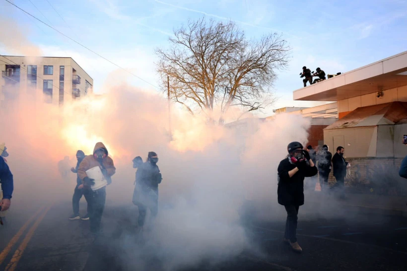 Federal agents lobbed tear gas and flash bangs at protesters in front of the ICE building on Jan. 31, 2026, in Portland, Ore. (Allison Barr/The Oregonian via AP)