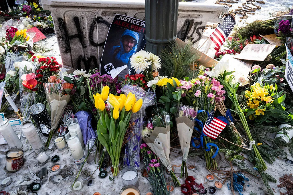 Flowers placed at the makeshift memorial for Alex Pretti, the day after he was murdered by federal agents on Jan. 24 in Minneapolis. (Photo by Roberto Schmidt/AFP via Getty Images)