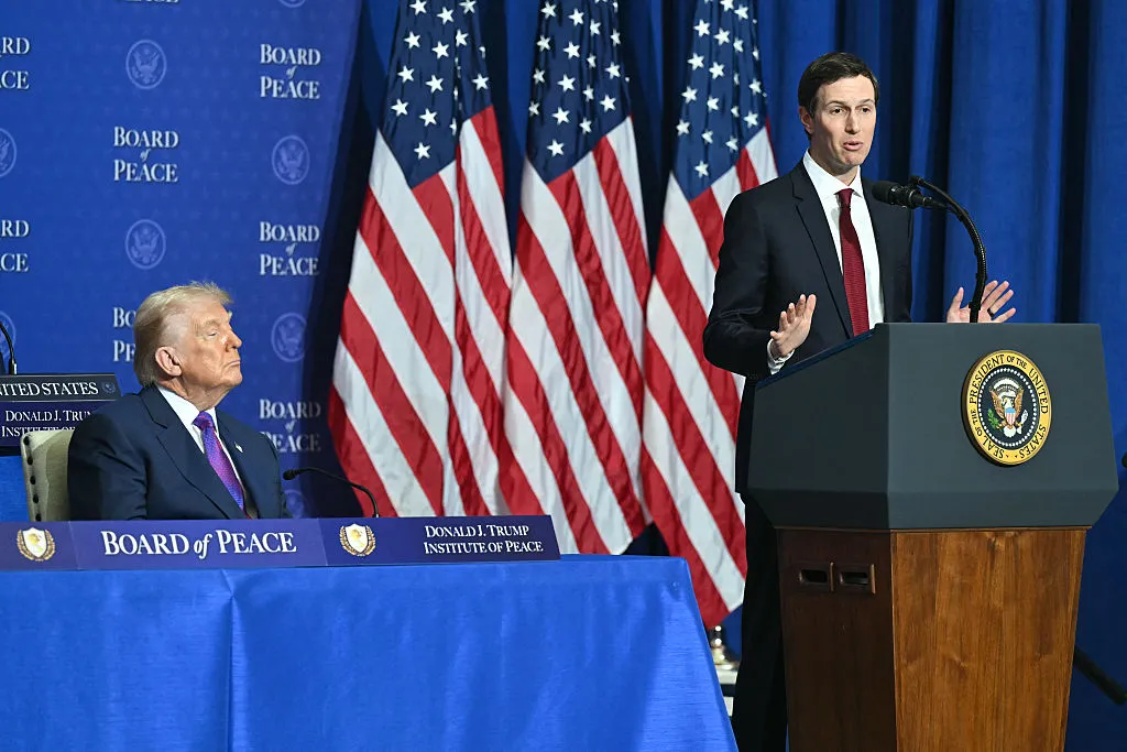 President Donald Trump looks on as his son-in-law Jared Kushner speaks during the inaugural meeting of the 
