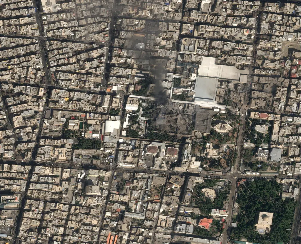 A satellite image shows black smoke rising and heavy damage at the compound of Iran’s supreme leader, Ayatollah Ali Khamenei.Credit...Airbus, via Reuters