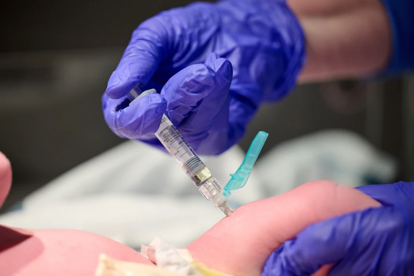 In this photo provided by Norton Healthcare, nurse Robin Waldridge administers a Vitamin K shot to a newborn baby at Norton Women’s and Children’s Hospital on Friday, March 6, 2026, at the hospital in Louisville, Ky. (Jamie Rhodes/Norton Healthcare via AP)