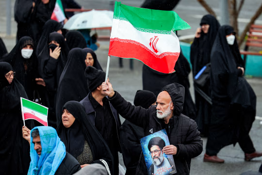 A mourner holding a portrait of slain leader Ayatollah Ali Khamenei at a funeral ceremony for assassinated intelligence minister Esmail Khatib in Tehran on Friday. AFP/Getty Images