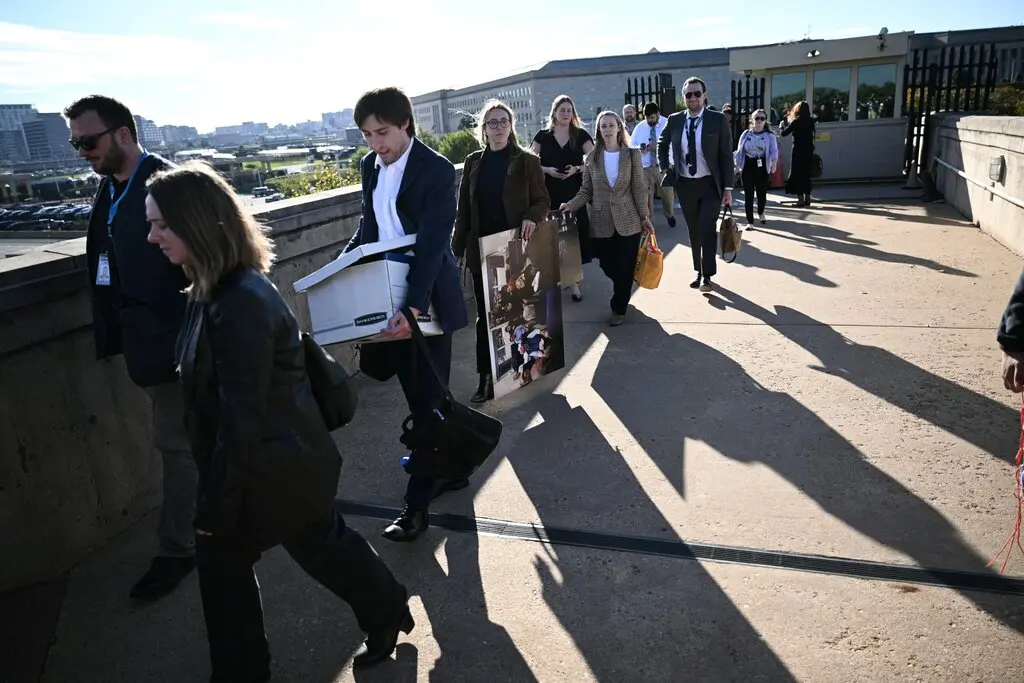 Reporters carried their belongings as they left the Pentagon after turning in their press passes last year.Credit...Brendan Smialowski/Agence France-Presse — Getty Images