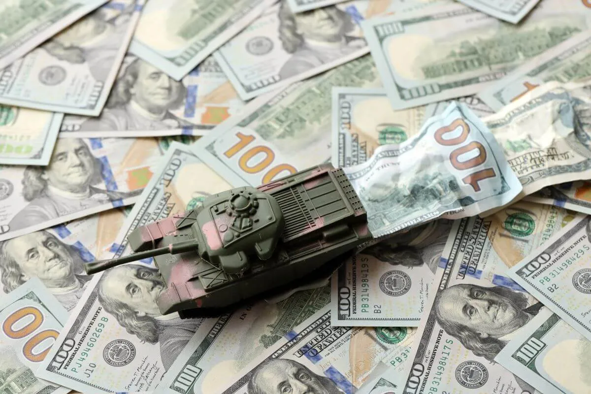 toy tank on hundred dollar bills