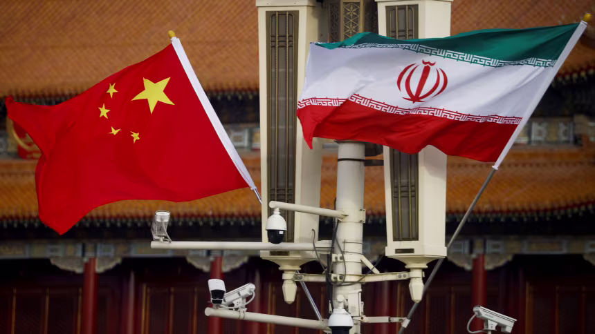 The national flags of China and Iran fly in Beijing's Tiananmen Square on February 14, 2023. Thomas Peter/Reuters/File